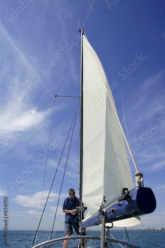 Sailor in sailboat rigging the sails © lunamarina