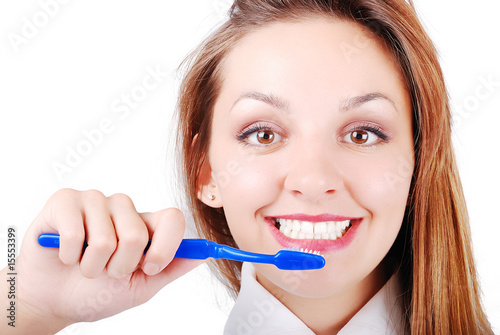 Beautiful attractive girl brushing her very white teeth