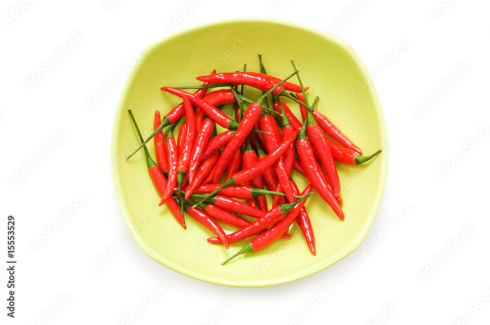 Peppers in plate isolated on the white Peppers in plate isolated on the white