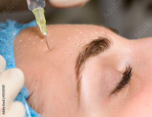 Cosmetic injection in woman's face