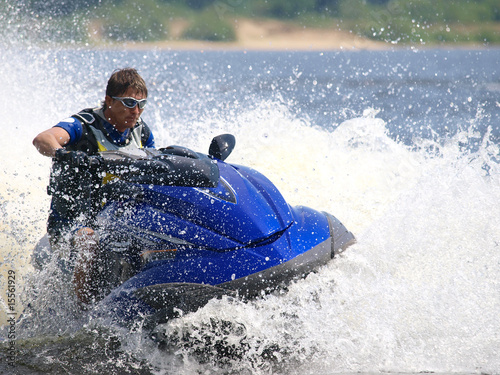 Man on jet-ski turns very fast with diving photo