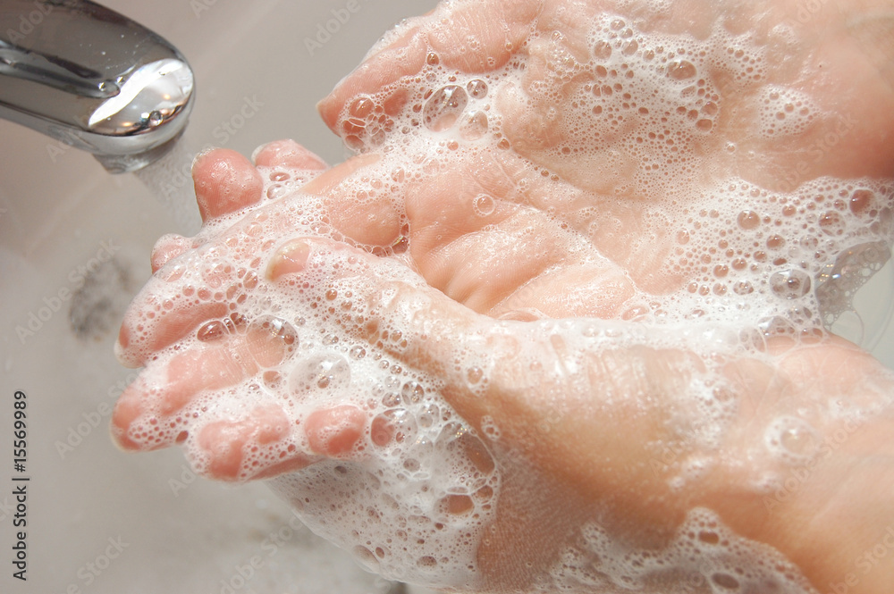 woman washing hand under running