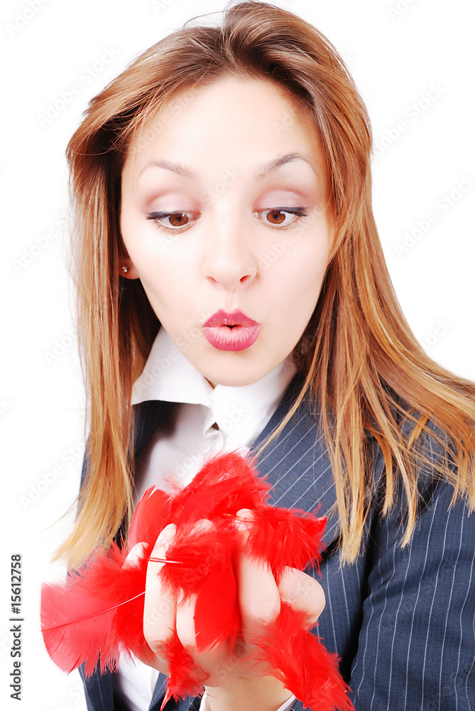 Beautiful attractive model puffing red feather in hand Beautiful attractive model puffing red feather in hand