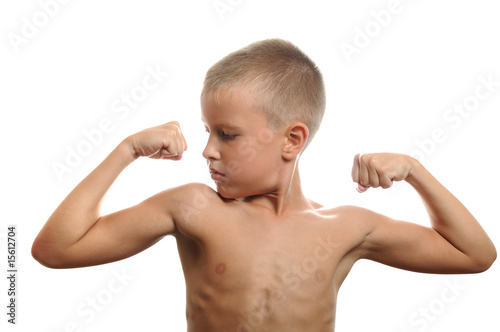 young boy flexes his muscles