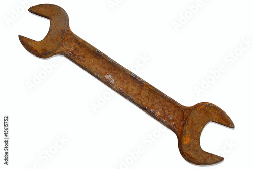 Rusty old spanner isolated on a white background.