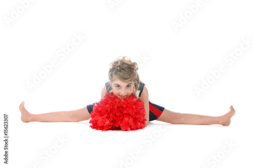 cheerleader girl doing a split and holding red pompom