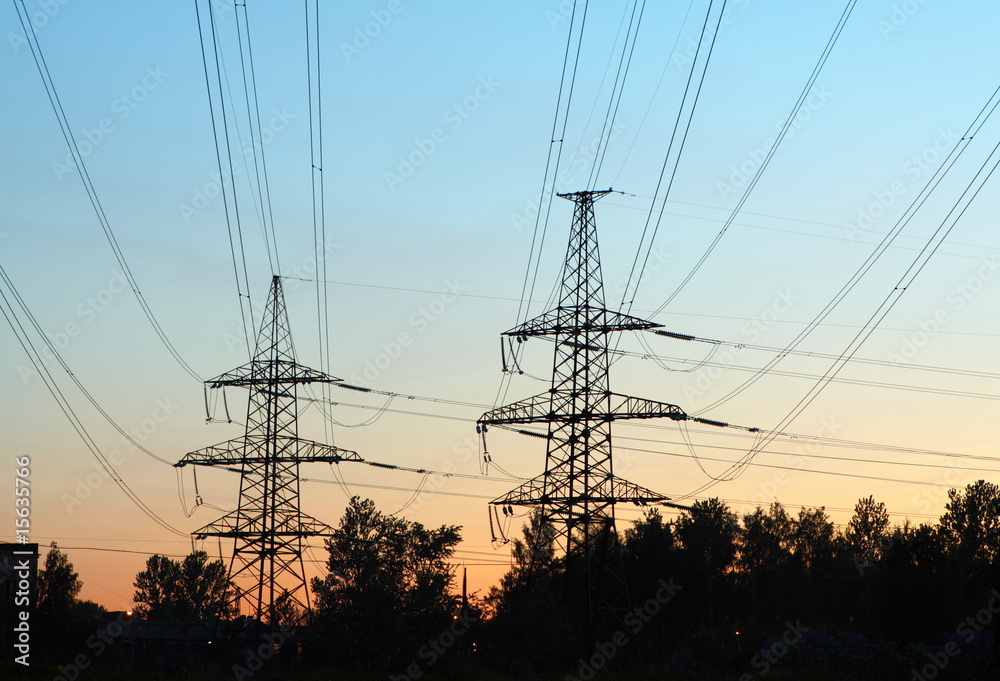 transmission line towers at sunrise