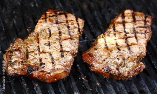 Good looking steak cooking on open grill