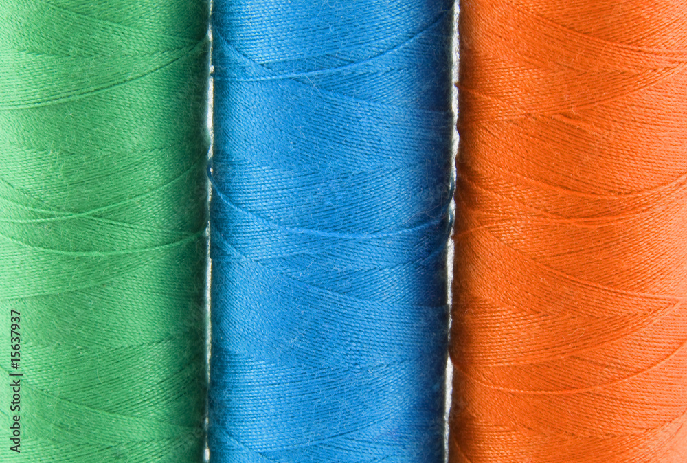Green, red, and blue colorful threads over background Green, red, and blue colorful threads over background