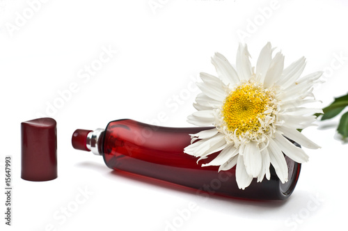 Open perfume bottle with oxeye daisy decoration