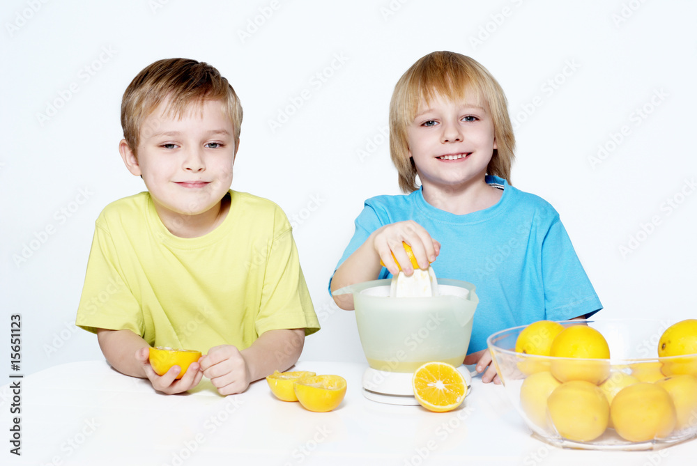 Children squeeze out orange juice Children squeeze out orange juice
