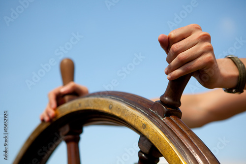 Hands on ship rudder. photo