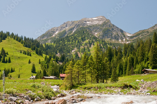 Gebirgsbach mit Dorf photo