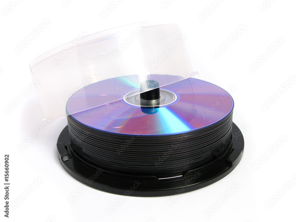 Stack of DVDs and CDs on white background Stack of DVDs and CDs on white background