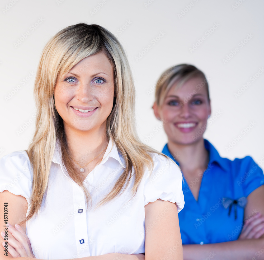Businesswoman smiling at the camera with her colleague Businesswoman smiling at the camera with her colleague