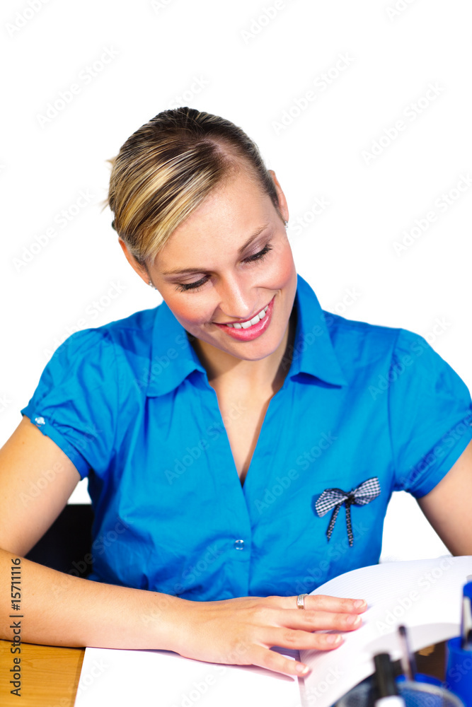 Blonde businesswoman reading reports in office Blonde businesswoman reading reports in office