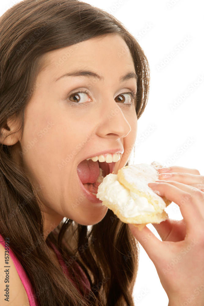 Portrait of young woman eating cake with cream Portrait of young woman eating cake with cream