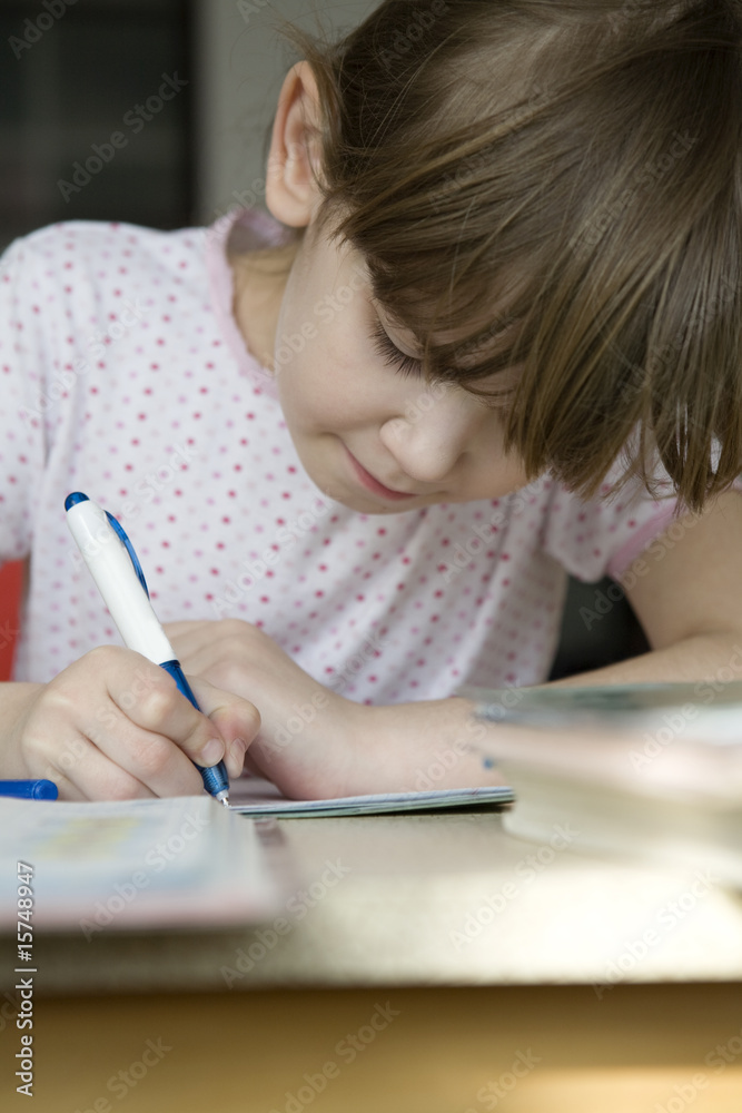little cute serious girl doing homework little cute serious girl doing homework