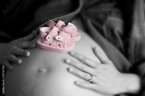 Pregnant woman holding her belly in black and white