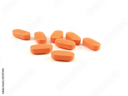 Orange pills, prescription drugs on white background