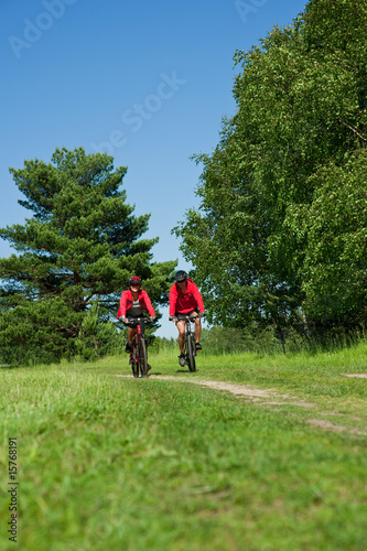 Young couple riding bike in the nature