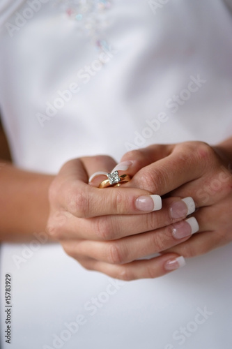 Bride holding her engagement ring.