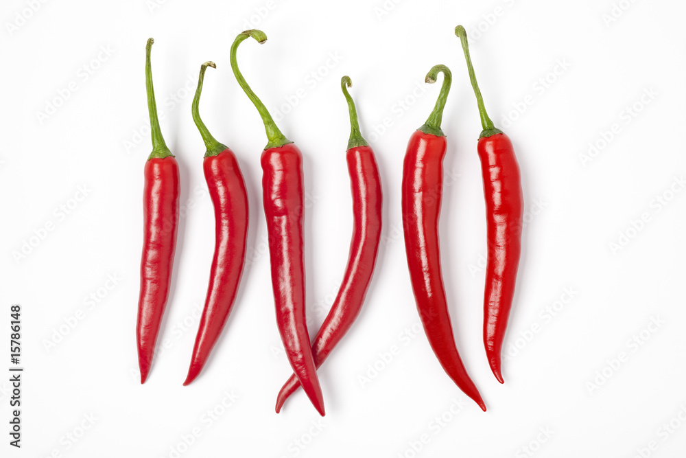 Six red hot chili peppers on a row