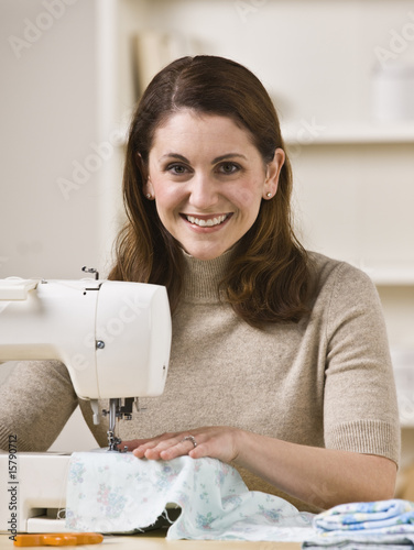 Smiling Woman Using Sewing Machine