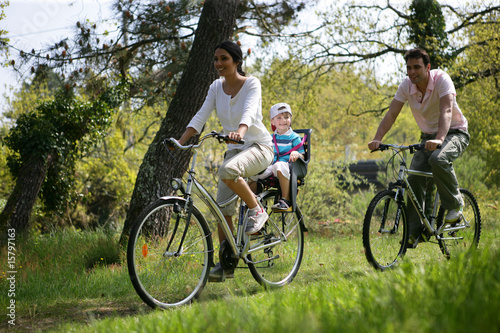 Couple avec un petit garçon faisant du vélo à la campagne