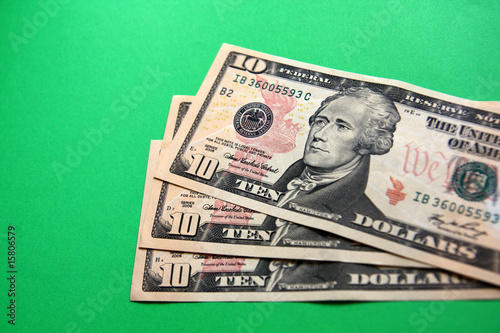 three 10 dollars banknote on the green background