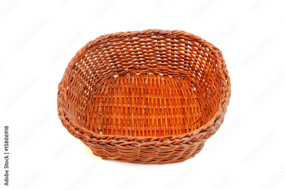 Fototapeta premium Empty orange wicker basket without handles isolated