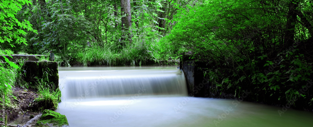 Obraz premium panoramic view of a waterfall in the English garden in Munich