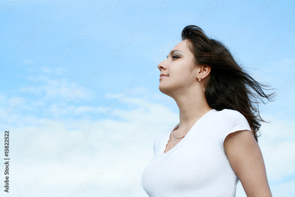 beautiful woman on a background of blue sky beautiful woman on a background of blue sky