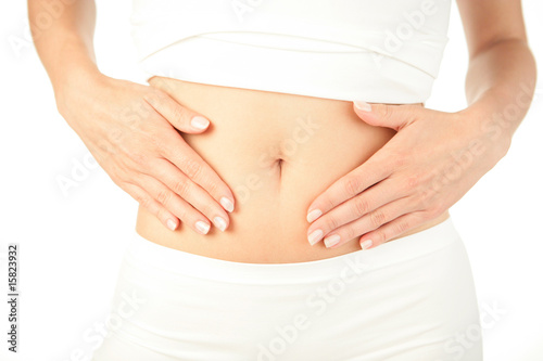 Closeup of young woman with hands on her stomach