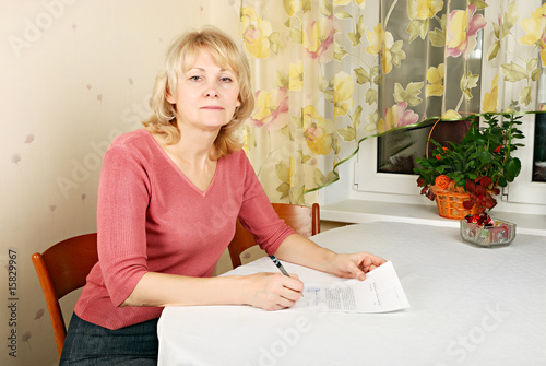 Adult blond woman with document