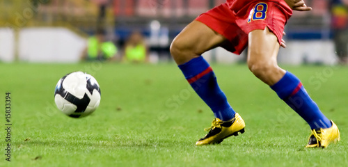 Soccer player running for the ball