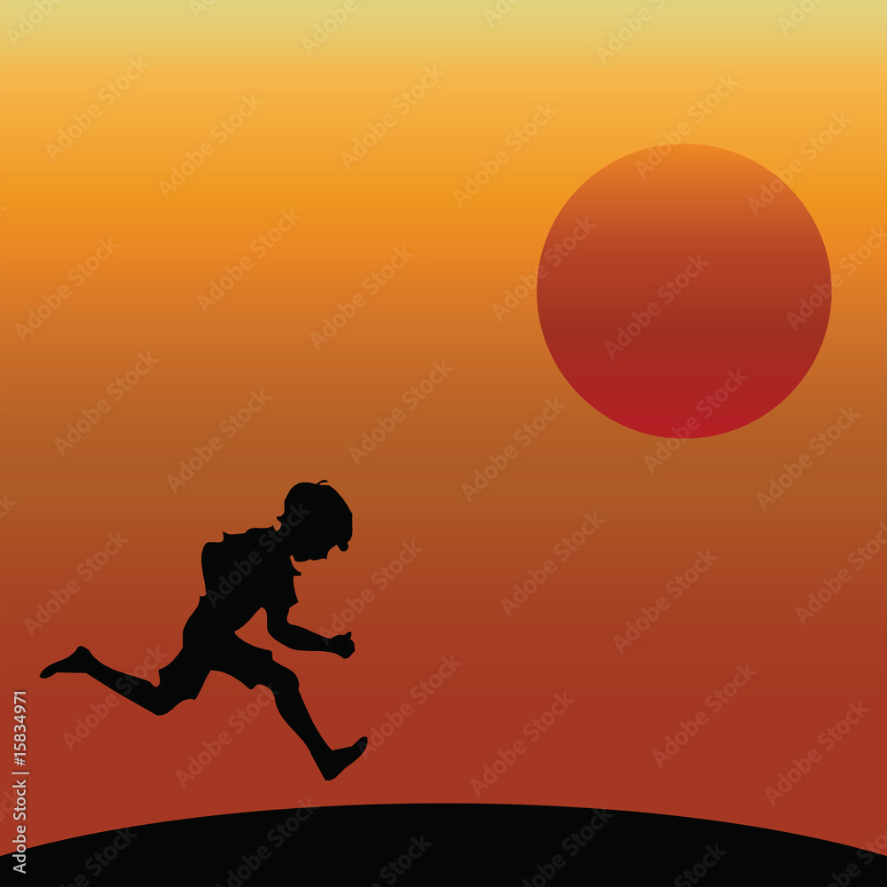 Young boy running silhouetted against a dawn or dusk sky Young boy running silhouetted against a dawn or dusk sky