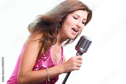 Beautiful girl with a microphone singing a song