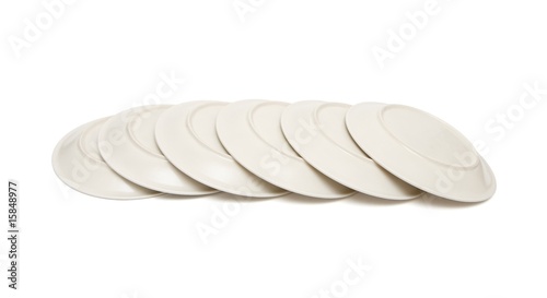 Stack of plain beige plates tiled upside down isolated