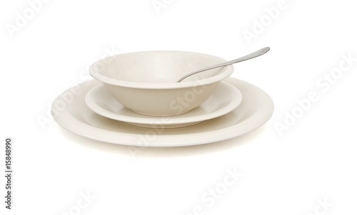 Plain beige soup, dinner plates and saucer with spoon isolated