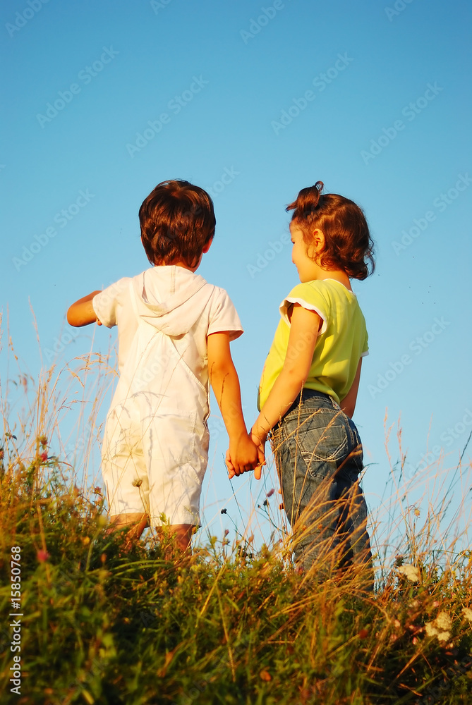 Romantic vision of two children standing together outdoor Romantic vision of two children standing together outdoor