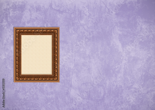 Grunge purple stucco wall with empty picture frame