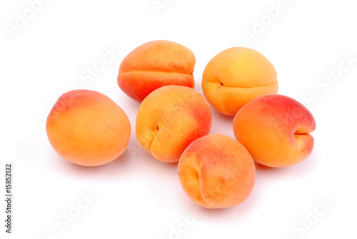 Ripe and juicy apricots on white