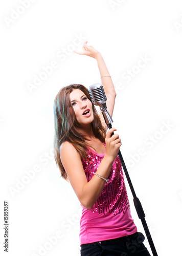 Beautiful girl singing a song holding classic microphone