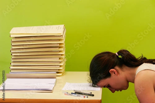 woman has stress because of huge work on her desk