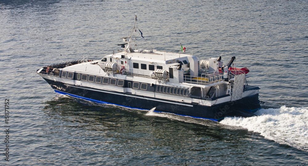 Obraz premium Blue and White Ferry Across Bay