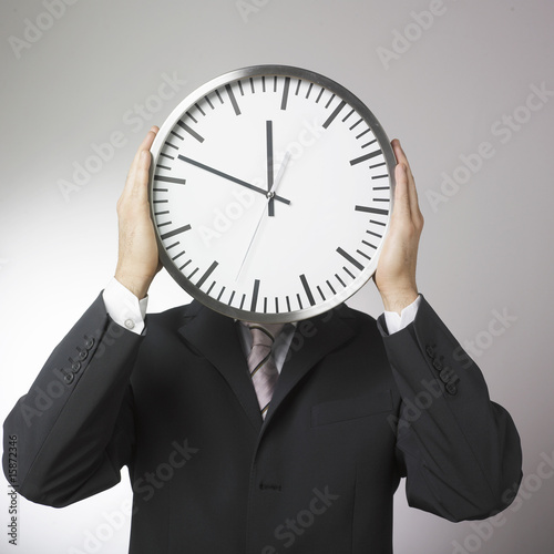 visage d'homme d'affaires horloge photo
