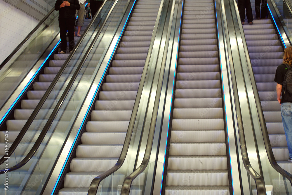 people on escalators in a department store people on escalators in a department store