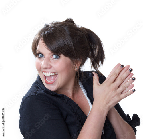 Young woman with hands clasped together and overjoyed