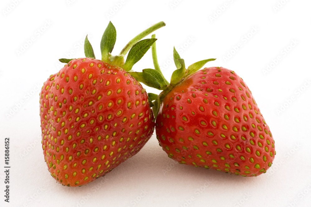 Two strawberries set against a white background Two strawberries set against a white background